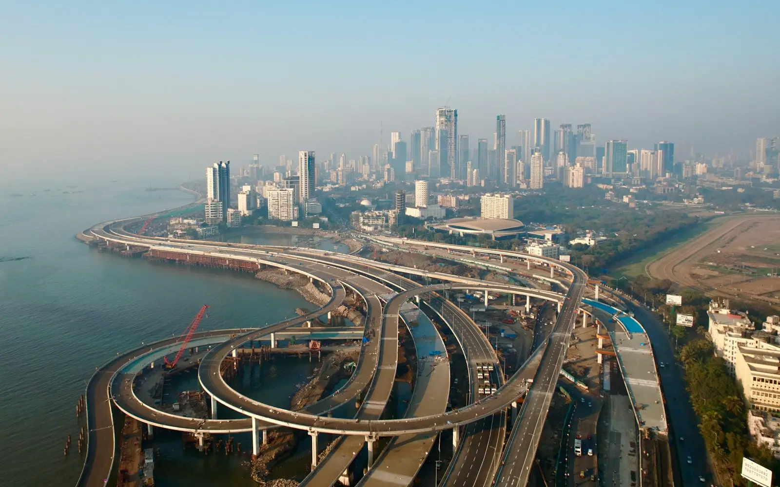 Aerial view of a coastal road interchange beside a city