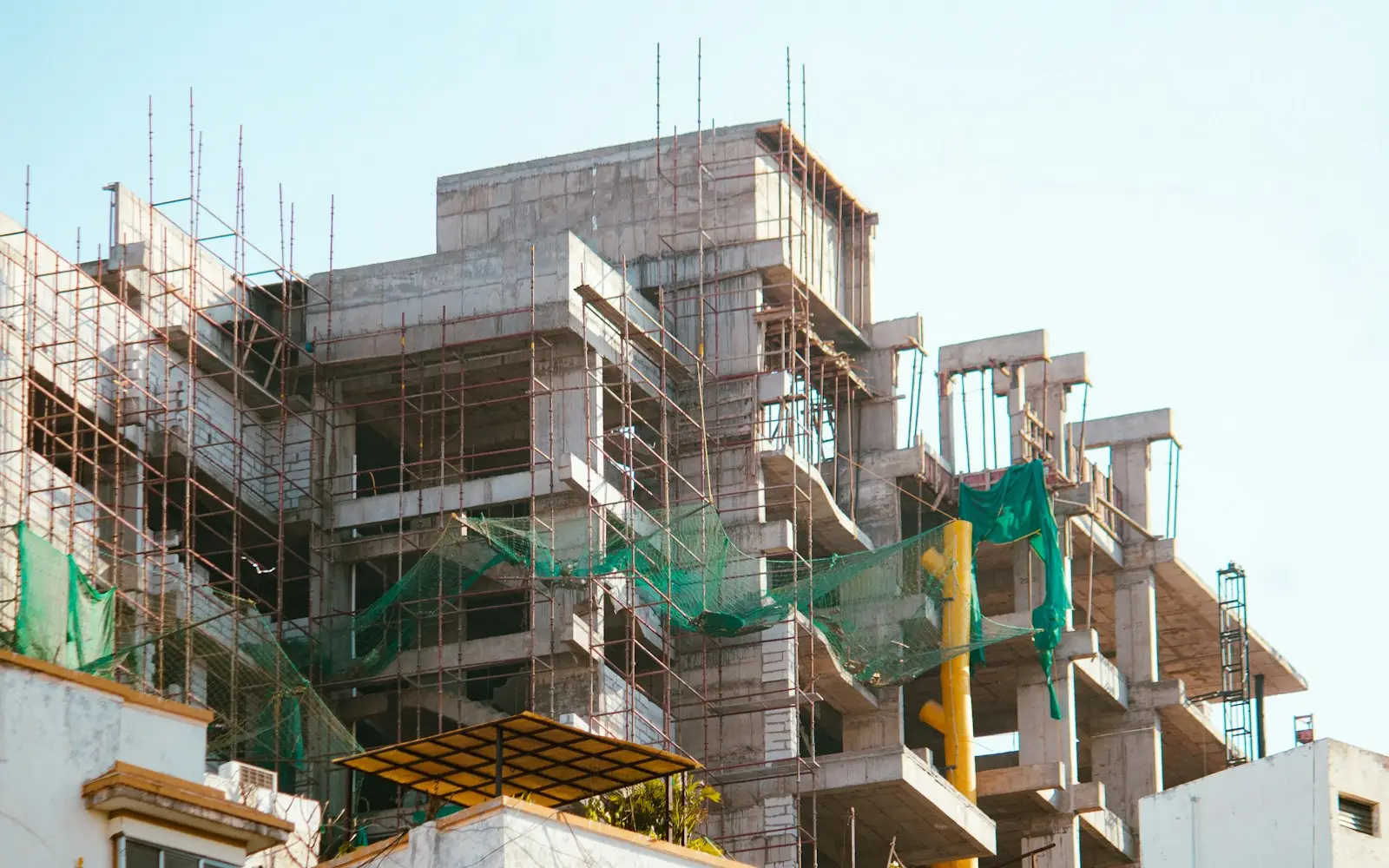 Residential building under construction, wrapped in scaffolding