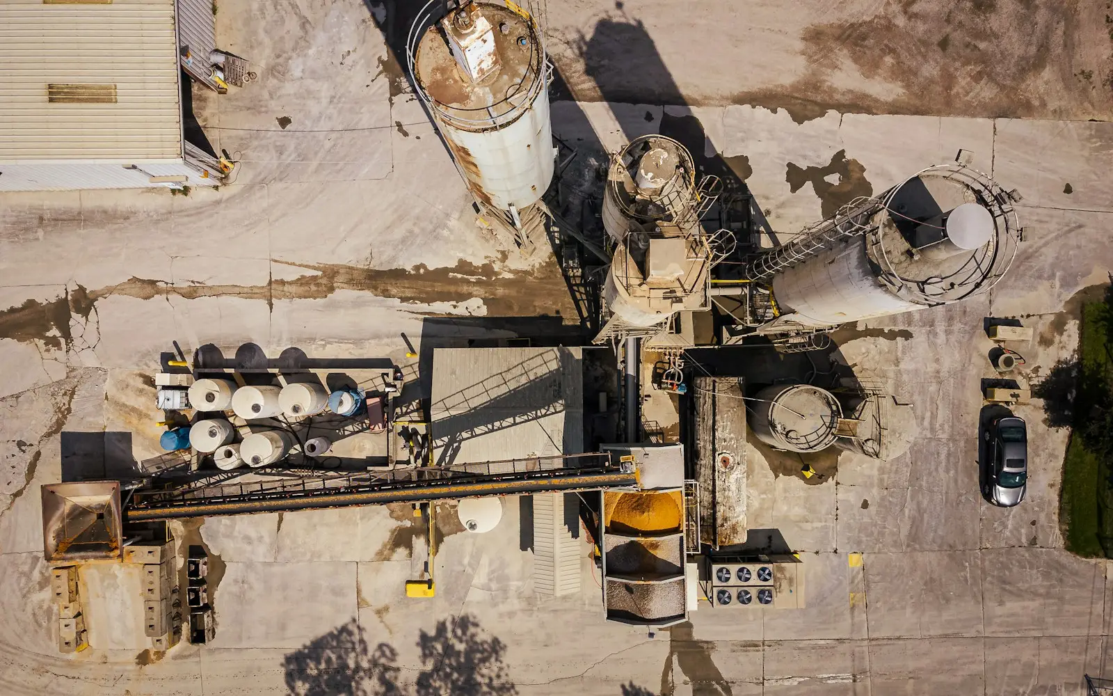 Aerial view of a ready-mix concrete batching plant with silos and aggregate bins